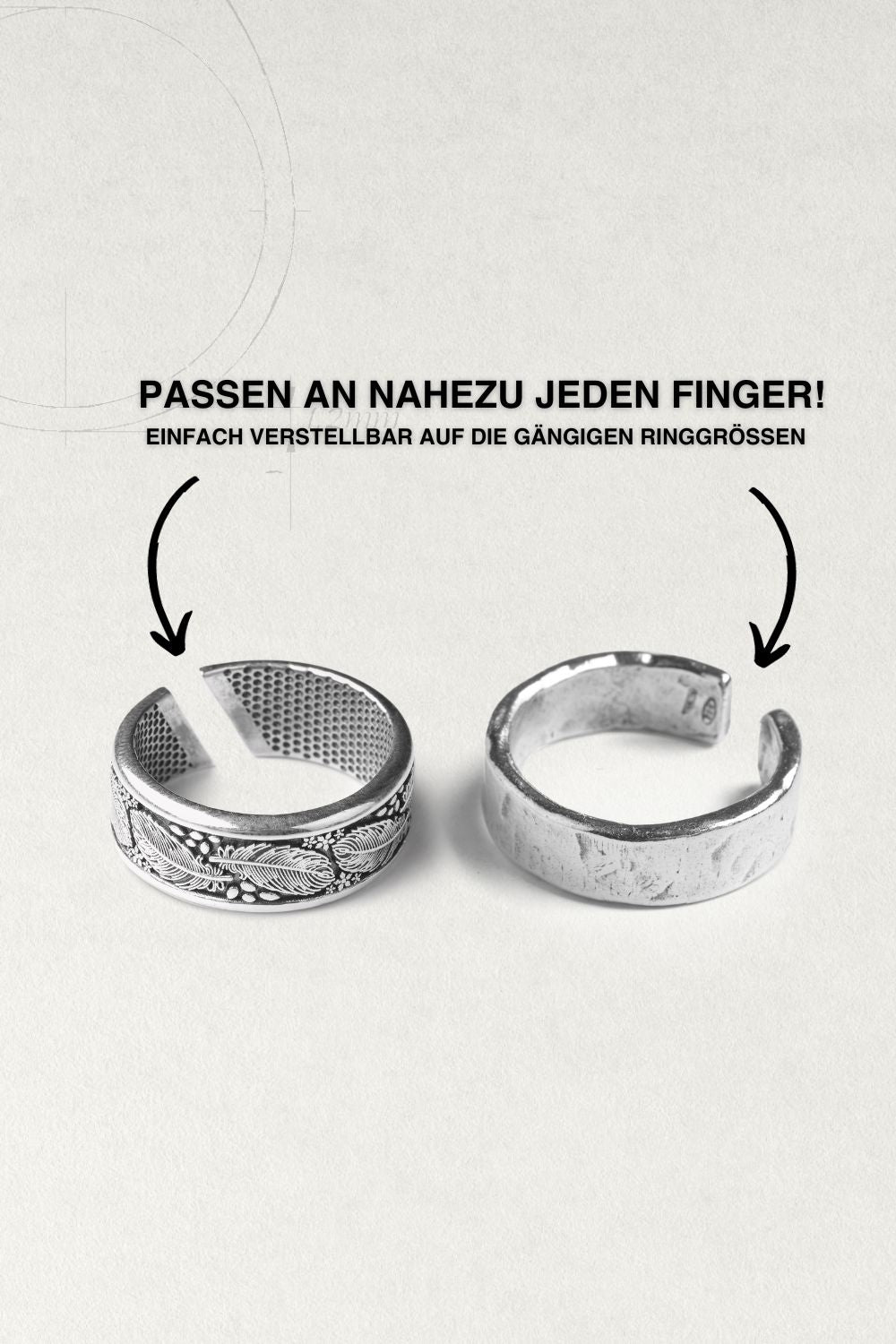 Two silver rings on a black, geometric-patterned background.